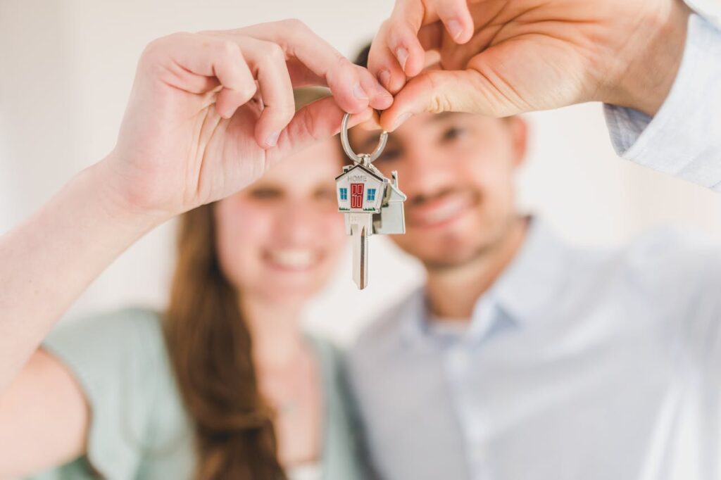 pexels-photo-8293700 Happy Couple Holding and Showing a House Key